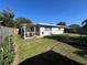 A well-maintained backyard with lush lawn, a patio, and a fenced perimeter, ideal for outdoor activities at 1748 Ragland Ave, Clearwater, FL 33765