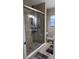 A bathroom featuring wood-look tile floors, a glass shower, and a window at 1748 Ragland Ave, Clearwater, FL 33765