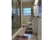 A bathroom featuring wood-look tile floors, a glass shower, and a white vanity at 1748 Ragland Ave, Clearwater, FL 33765