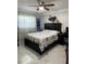 A bedroom with wood-look tile floors, a black bed frame, and a ceiling fan at 1748 Ragland Ave, Clearwater, FL 33765