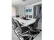 Dining room featuring a sleek white table, modern chairs, and wall art at 1748 Ragland Ave, Clearwater, FL 33765