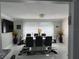 Dining room with a modern white table, black chairs, and decorative flower vases by the window at 1748 Ragland Ave, Clearwater, FL 33765