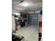 Spacious garage is equipped with overhead door and storage, providing versatile space for parking and hobbies at 1748 Ragland Ave, Clearwater, FL 33765