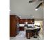 Spacious kitchen with dark wood cabinetry, stainless steel appliances, and a granite island with seating at 1748 Ragland Ave, Clearwater, FL 33765