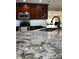 Close-up of a kitchen featuring granite countertops, a stainless steel sink, and modern appliances at 1748 Ragland Ave, Clearwater, FL 33765