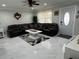 Cozy living room featuring a large sofa, modern tile flooring, and an elegant ceiling fan at 1748 Ragland Ave, Clearwater, FL 33765