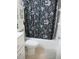 Bathroom with a white vanity, toilet, and a shower with a dark floral curtain at 2001 World Parkway Blvd # 49, Clearwater, FL 33763