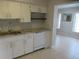 Bright kitchen features white cabinets, subway tile backsplash, granite counters, and stainless faucet at 2001 World Parkway Blvd # 49, Clearwater, FL 33763