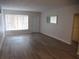 Bright living room with hardwood floors, a window, and a white door at 2001 World Parkway Blvd # 49, Clearwater, FL 33763