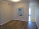 Living room with hardwood floors, a rectangular mirror, and white walls at 2001 World Parkway Blvd # 49, Clearwater, FL 33763