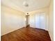 Bright bedroom featuring wood-look flooring and closet storage at 2331 Finlandia Ln # 73, Clearwater, FL 33763