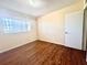 Bright bedroom featuring wood-look flooring and a window bringing in natural light at 2331 Finlandia Ln # 73, Clearwater, FL 33763