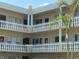 Multi-level condo building with outdoor balconies and tropical landscaping, offering a relaxed living environment at 2331 Finlandia Ln # 73, Clearwater, FL 33763