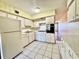Functional kitchen with white appliances, tile floor, and convenient layout, ready for culinary adventures at 2331 Finlandia Ln # 73, Clearwater, FL 33763