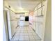 Well-equipped kitchen with white appliances, ample cabinet space, and durable tile flooring at 2331 Finlandia Ln # 73, Clearwater, FL 33763