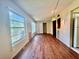 Spacious living room with wood-look flooring and large windows, leading into the kitchen at 2331 Finlandia Ln # 73, Clearwater, FL 33763