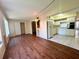 Open living room next to the kitchen with white cabinets and tiled floor at 2331 Finlandia Ln # 73, Clearwater, FL 33763