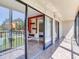 Balcony view with sliding doors and a glimpse of the interior with decorative shelves and a bedroom at 2700 Cove Cay Dr # 1-2D, Clearwater, FL 33760