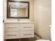 Bathroom featuring a white vanity with four drawers, chrome hardware and a large mirror at 2700 Cove Cay Dr # 1-2D, Clearwater, FL 33760