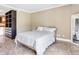 Cozy bedroom with a sleek closet system, a bed with white linens and neutral colored walls at 2700 Cove Cay Dr # 1-2D, Clearwater, FL 33760