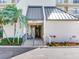 Main entrance to the building with red flowers and a palm tree, with a fire hydrant and small staircase at 2700 Cove Cay Dr # 1-2D, Clearwater, FL 33760