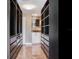 View into walk-in closet showing custom shelves and drawers leading to the bathroom at 2700 Cove Cay Dr # 1-2D, Clearwater, FL 33760