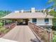 Beautiful building with inviting wood bridge and landscaped surroundings on clear day at 2700 Cove Cay Dr # 1-2D, Clearwater, FL 33760