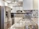 Updated kitchen with stainless steel appliances, granite countertops and tile backsplash at 2700 Cove Cay Dr # 1-2D, Clearwater, FL 33760