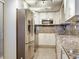 Modern kitchen featuring stainless steel appliances, custom cabinets, and granite countertops at 2700 Cove Cay Dr # 1-2D, Clearwater, FL 33760