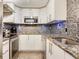 Updated kitchen features stainless appliances, granite counters, and modern fixtures at 2700 Cove Cay Dr # 1-2D, Clearwater, FL 33760