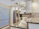 Kitchen view featuring stainless appliances, granite countertops and tiled backsplash at 2700 Cove Cay Dr # 1-2D, Clearwater, FL 33760