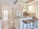 Bright kitchen featuring granite countertops, a tiled backsplash and two barstools at 2700 Cove Cay Dr # 1-2D, Clearwater, FL 33760