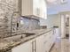 Kitchen featuring stainless faucet, granite countertop, and backsplash at 2700 Cove Cay Dr # 1-2D, Clearwater, FL 33760