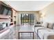 Bright living room with marble floors, modern fireplace, and sliding glass doors showcasing a lush golf course at 2700 Cove Cay Dr # 1-2D, Clearwater, FL 33760