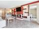 Spacious living room featuring an open layout with a fireplace, bar seating, and comfortable sofa at 2700 Cove Cay Dr # 1-2D, Clearwater, FL 33760