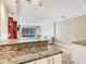 Kitchen flows into living room with bright windows, sofa and tile floors at 2700 Cove Cay Dr # 1-2D, Clearwater, FL 33760