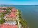 Aerial view of waterfront condos featuring lush greenery and a scenic walking path at 2739 Via Capri # 1024, Clearwater, FL 33764