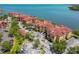 Waterfront community, showcasing well-maintained buildings, parking, and lush greenery along the coastline at 2739 Via Capri # 1024, Clearwater, FL 33764