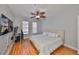 Bright bedroom featuring hardwood floors, a ceiling fan, and large windows with natural light at 2739 Via Capri # 1024, Clearwater, FL 33764