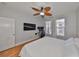Comfortable bedroom featuring a ceiling fan, wood flooring, and large windows at 2739 Via Capri # 1024, Clearwater, FL 33764