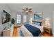 Cozy bedroom with a decorative ceiling fan, hardwood floors, and an inviting queen-sized bed at 2739 Via Capri # 1024, Clearwater, FL 33764