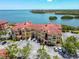Mediterranean-style condos feature red tile roofs, lush landscaping, and convenient parking near the bay at 2739 Via Capri # 1024, Clearwater, FL 33764