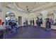 Well-equipped fitness center with weight machines, mirrors, and ceiling fans at 2739 Via Capri # 1024, Clearwater, FL 33764