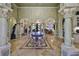 Grand foyer with marble floors, soaring ceilings, stately columns, and elegant chandelier at 2739 Via Capri # 1024, Clearwater, FL 33764