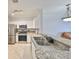 Kitchen area featuring a granite counter, stainless steel appliances, and neutral color scheme at 2739 Via Capri # 1024, Clearwater, FL 33764
