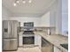 Bright kitchen features stainless steel appliances and granite countertops at 2739 Via Capri # 1024, Clearwater, FL 33764