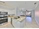 Open-concept kitchen with stainless steel appliances, granite countertops, and views into the living area at 2739 Via Capri # 1024, Clearwater, FL 33764