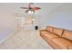 Spacious living room featuring tile flooring and a large leather sofa at 2739 Via Capri # 1024, Clearwater, FL 33764