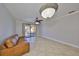 Spacious living room with tiled floors and sliding glass door to the balcony at 2739 Via Capri # 1024, Clearwater, FL 33764