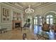 Luxury living room with a fireplace, chandelier, marble floors, and decorative columns at 2739 Via Capri # 1024, Clearwater, FL 33764